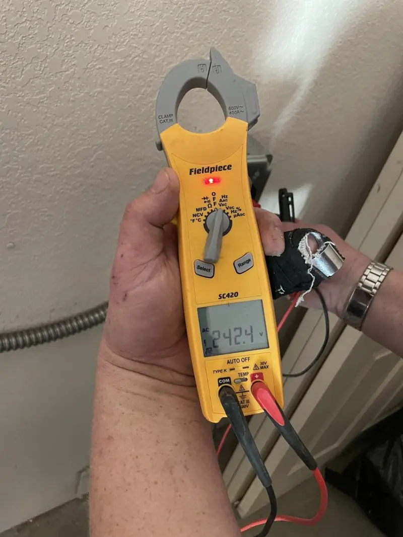 Voltage testing with clamp meter during Outlet Installation in Owego